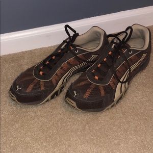 Puma soccer style sneakers in brown and orange.